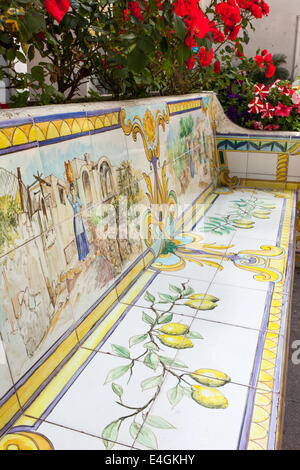 Bench of ceramic tiles decorated with lemons and human figures, Capri. Stock Photo