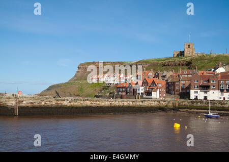 View of Whitby harbour showing the cliffs above the town and the church. Stock Photo