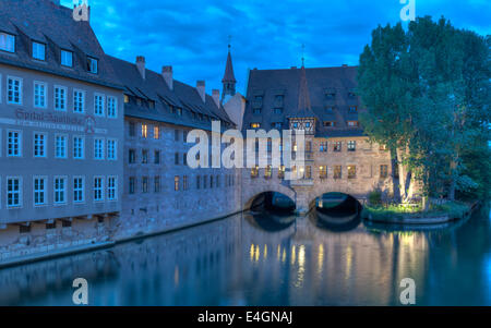 The Heilig-Geist-Spital in Nuremberg, Germany which dates from 1424 on the river Pegnitz Stock Photo