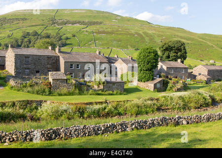Evening light over the village of Thwaite, Upper Swaledale, Yorkshire Dales National Park, England, UK Stock Photo
