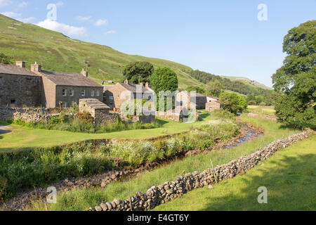Evening light over the village of Thwaite, Upper Swaledale, Yorkshire Dales National Park, England, UK Stock Photo