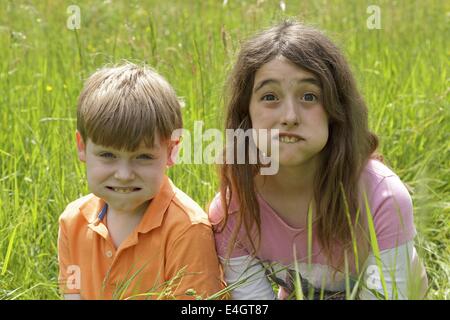 two children making grimaces Stock Photo