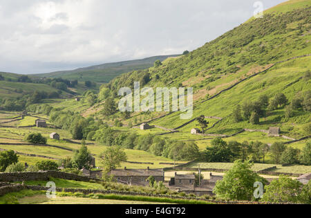 Evening light over the village of Thwaite, Upper Swaledale, Yorkshire Dales National Park, England, UK Stock Photo