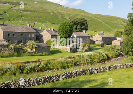 Evening light over the village of Thwaite, Upper Swaledale, Yorkshire Dales National Park, England, UK Stock Photo