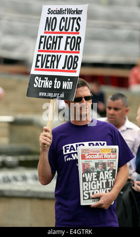 Swansea, UK. 10th July, 2014.  Pictured: A man holding a Socialist Workers placard reading 'No Cuts Fight for Every Job' at Castle Square Gardens, Swansea, south Wales.  Re: Strikes are taking place across the UK in a series of disputes with the government over pay, pensions and cuts, with more than a million public sector workers expected to join the action.  Firefighters, librarians and council staff are among those taking part from several trade unions, with rallies taking place across the UK. Credit:  D Legakis/Alamy Live News Stock Photo