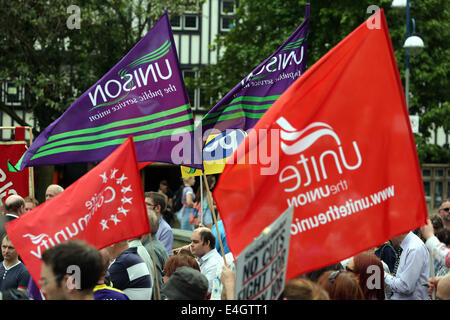 Swansea, UK. 10th July, 2014.  Pictured: PCS, Unite and Unison flags flying at Castle Square Gardens, Swansea, south Wales.  Re: Strikes are taking place across the UK in a series of disputes with the government over pay, pensions and cuts, with more than a million public sector workers expected to join the action.  Firefighters, librarians and council staff are among those taking part from several trade unions, with rallies taking place across the UK. Credit:  D Legakis/Alamy Live News