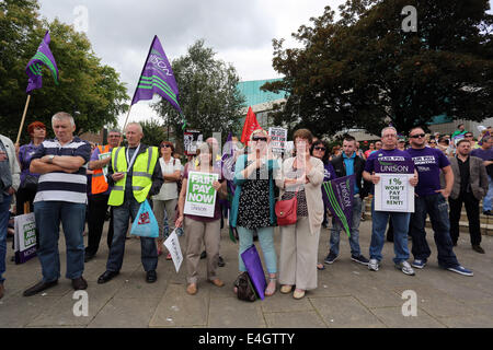 Swansea, UK. 10th July, 2014.  Pictured: Members of Unison at Castle Square Gardens, Swansea, south Wales.  Re: Strikes are taking place across the UK in a series of disputes with the government over pay, pensions and cuts, with more than a million public sector workers expected to join the action.  Firefighters, librarians and council staff are among those taking part from several trade unions, with rallies taking place across the UK. Credit:  D Legakis/Alamy Live News