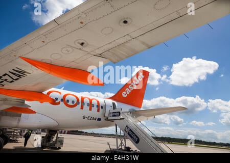 Under the wing of an EasyJet aircraft ready for boarding.