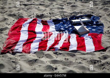 Stars and stripes towel at Pacific Beach, on Fourth of July 2014. Stock Photo