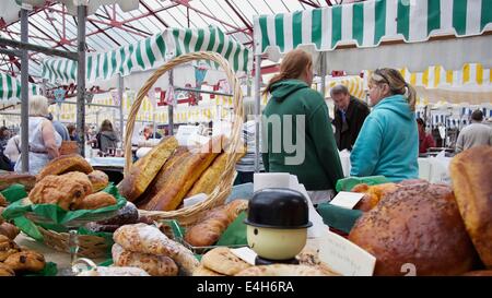 Scenes from Altrincham Market:Farmers' Maarket - stall holders pause for a chat Stock Photo