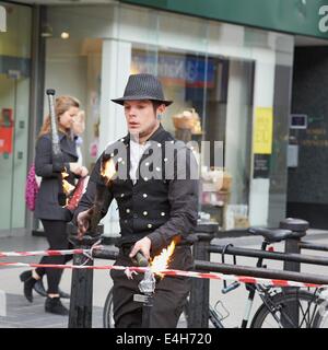 Scenes from Altrincham: Fire-eater and juggler entertains passers by Stock Photo