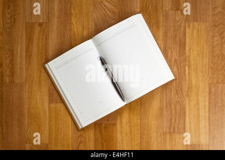 Blank notepad with office supplies on wooden table. Above view. Stock Photo