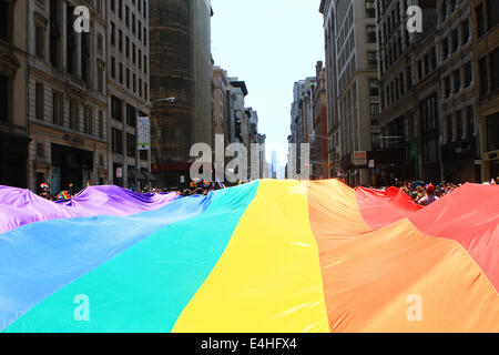 View of rainbow banner being carried at the 45th annual New York City Gay Pride Parade on Fifth Avenue in New York, New York. Stock Photo