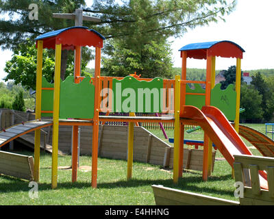 cheerful children's playground is located in a wooden board Stock Photo