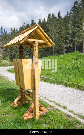 Wooden trash can in park, near forest Stock Photo