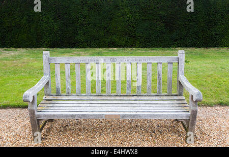 Wooden bench seat in the gardens of Sandringham House, Norfolk, inscribed 'Queen Elizabeth II Silver Jubilee 1977'