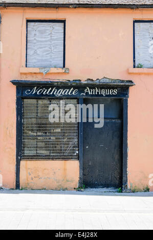 A derelict and closed up antiques shop Stock Photo