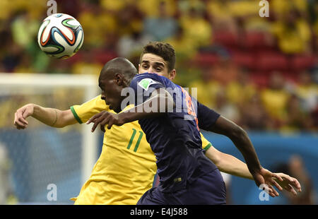 Brasilia, Brazil. 12th July, 2014. Netherlands' Bruno Martins Indi vies with Brazil's Oscar during the third place play-off match between Brazil and Netherlands of 2014 FIFA World Cup at the Estadio Nacional Stadium in Brasilia, Brazil, on July 12, 2014. Credit:  Yang Lei/Xinhua/Alamy Live News Stock Photo