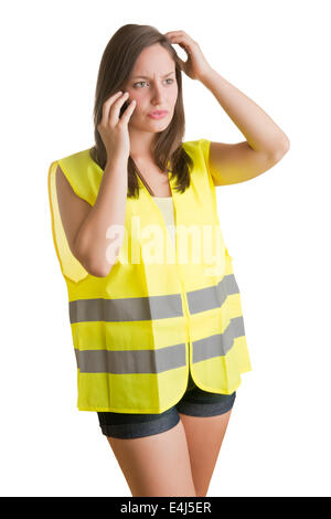 Woman talking on the phone wearing a reflector vest, isolated in white Stock Photo