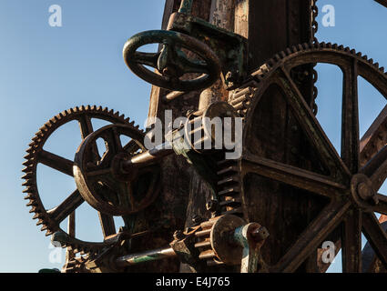 The base of an old dock crane showing gears and cogs Stock Photo