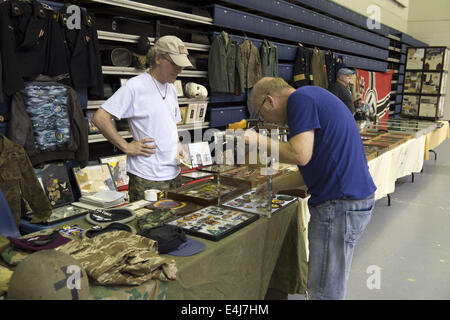 Marietta, GA, USA. 11th July, 2014. Antique military guns show and sale, Marietta GA, where WW2 and other wars' flags, weapons, uniforms, ammunition, etc. are bought and sold between collectors. Pictured: Uniform parts and patches for sale © Robin Rayne Nelson/ZUMA Wire/Alamy Live News Stock Photo
