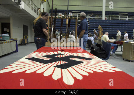 Marietta, GA, USA. 11th July, 2014. Antique military guns show and sale, Marietta GA, where WW2 and other wars' flags, weapons, uniforms, ammunition, etc. are bought and sold between collectors. Pictured: German flag and weapons for sale © Robin Rayne Nelson/ZUMA Wire/Alamy Live News Stock Photo