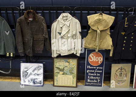 Marietta, GA, USA. 11th July, 2014. Antique military guns show and sale, Marietta GA, where WW2 and other wars' flags, weapons, uniforms, ammunition, etc. are bought and sold between collectors. Pictured: WW2 uniforms and posters © Robin Rayne Nelson/ZUMA Wire/Alamy Live News Stock Photo