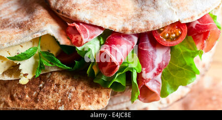 oriental bread with smoked meat and greens. Stock Photo