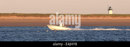 fishing boat off Provincetown MA Race point Lighthouse Stock Photo