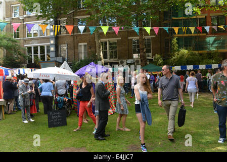 Soho, London, UK. 13th July 2014. The Soho Village Fete celebrates its 40th year with stalls, entertainments and the return of the waiters race. Credit:  Matthew Chattle/Alamy Live News Stock Photo