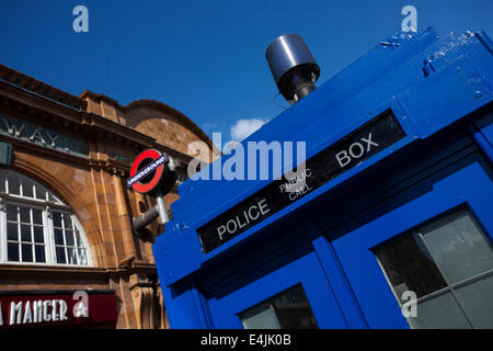 LONDON - JUNE 11, 2014: Public call police box with mounted a modern surveillance camera near Earl's Court tube station in Londo Stock Photo