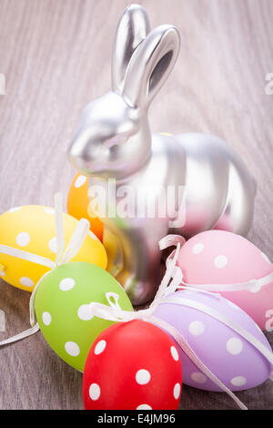 Collection of four hand decorated colourful green Easter eggs with different patterns displayed in straw, close up view Stock Photo