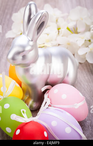 Collection of four hand decorated colourful green Easter eggs with different patterns displayed in straw, close up view Stock Photo