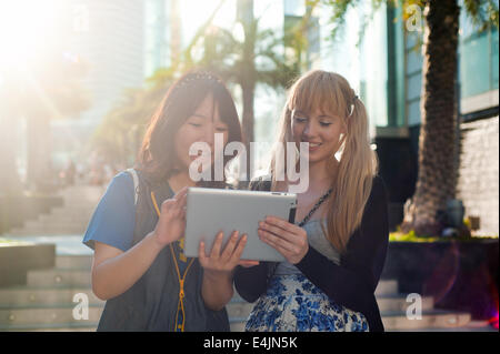 Two young women using digital tablet Stock Photo