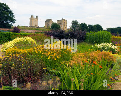 Helmsley Castle overlooking the Helmsley Walled Garden with a show of summer flowers Stock Photo