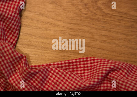 Red and White chequered tablecloth on wooden table Stock Photo