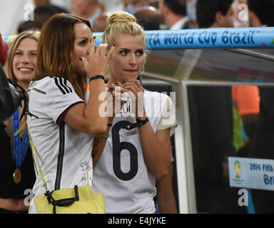 Rio de Janeiro, Brazil. 13th July, 2014. Sarah Brandner (L-R), girlfriend of Germany's Bastian Schweinsteiger, Sylwia, wife of Miroslav Klose of Germany, and Lena Gercke, girlfriend of Germany's Sami Khedira seen after the FIFA World Cup 2014 final soccer match between Germany and Argentina at the Estadio do Maracana in Rio de Janeiro, Brazil, 13 July 2014. Photo: Andreas Gebert/dpa/Alamy Live News Stock Photo