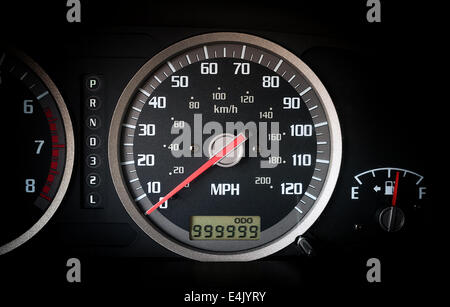 Close up image of illuminated car dashboard with 999999 miles on odometer Stock Photo