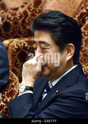 Tokyo, Japan. 14th July, 2014. Prime Minister Shizo Abe contemplates as Japanese lawmakers meet in the Diet lower house to deliberate the nation's right to collective self-defense in Tokyo on Monday, July 14, 2014. Abe is determined to have the new Japan-U.S. Defense Cooperation Guidelines to be revised late this year. Credit:  Natsuki Sakai/AFLO/Alamy Live News Stock Photo