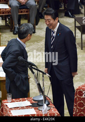 Tokyo, Japan. 14th July, 2014. Prime Minister Shizo Abe, right, exchange a few words with Masahiko Komura, a veteram lawmaker of Abe's Liberal Democratic Party, prior to the start of a Diet lower house deliberation on Japan's right to collective self-defense in Tokyo on Monday, July 14, 2014. Credit:  Natsuki Sakai/AFLO/Alamy Live News Stock Photo