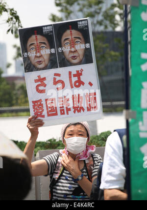 Tokyo, Japan. 14th July, 2014. A woman takes part in a protest against Japan's conservative leader Shinzo Abe and his move on lifting ban on collective self-defense, near the Diet building in Tokyo, Japan, July 14, 2014. About four hundred Japanese demonstrators on Monday here took part in the protest, as the Japanese parliament kicked off a special session targeting the Abe's Cabinet's decision on collective self-defense. Credit:  Liu Tian/Xinhua/Alamy Live News Stock Photo