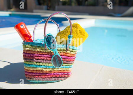 Vacation with beach bag and towels at the swimming pool