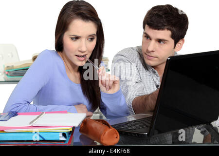 A couple of students doing homeworks. Stock Photo