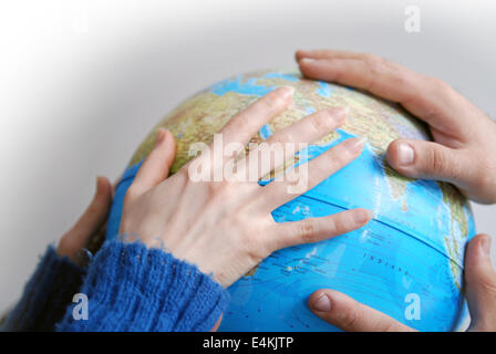 Teamwok concept with hands on globe Stock Photo