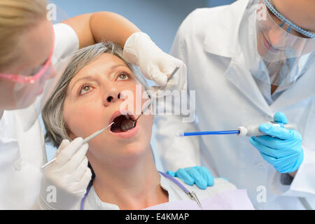 Dental check elderly woman patient professional dentist team open mouth Stock Photo