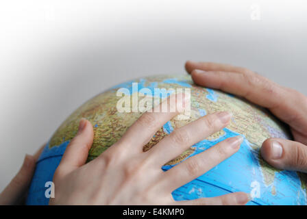 Teamwok concept with hands on globe Stock Photo