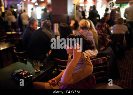 A young woman in a pub on a weekend night in Cardiff, Wales, UK Stock Photo