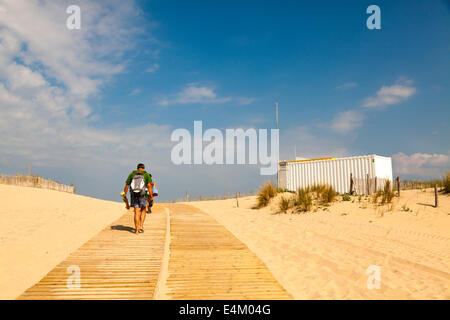 Heading to the sea over the dunes on the wooden slatted beach access ramp. Stock Photo