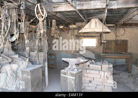 Interior of a wild west blacksmith shop adorned with bridles and reins Stock Photo