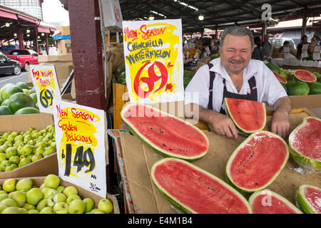 Melbourne Australia,Queen Victoria Market,vendor stall booth market marketplace,selling sale display produce watermelons apples man male signs prices Stock Photo